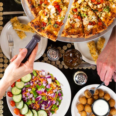 Top down shot of a table at Glass Nickel Pizza where guests are enjoying their food